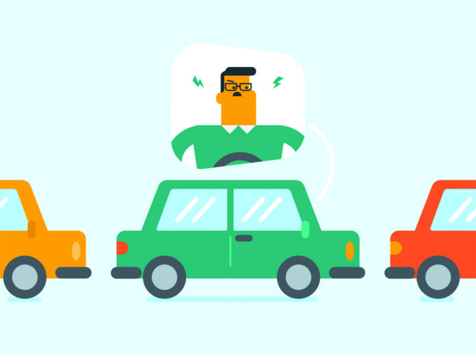 Angry caucasian man in car stuck in traffic jam.